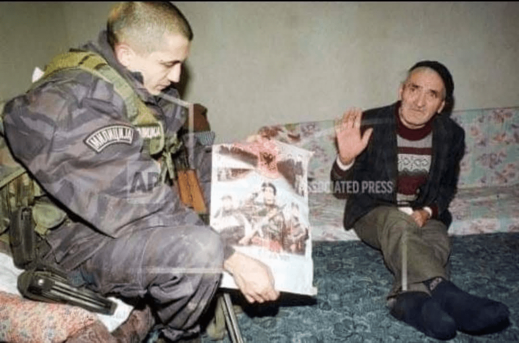 Serbian paramilitary forces harasses an Albanian elderly in his home