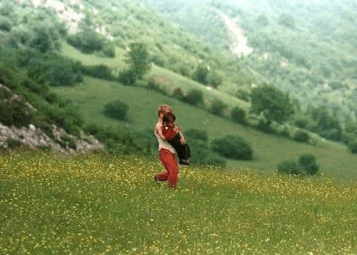 An 11-year old Albanian child flees the Serbian artillery shelling in Junik in August 1998